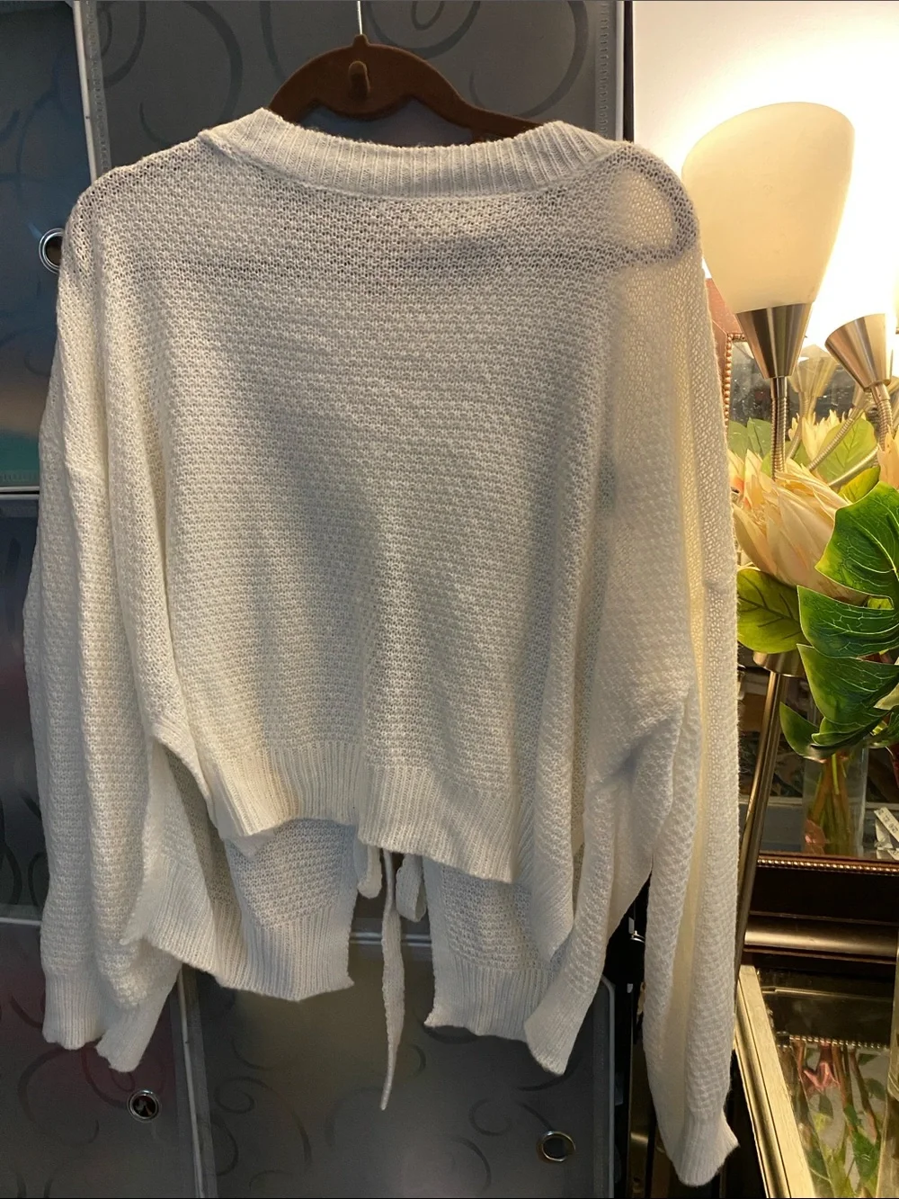 White Women’s Knit Sweater with Tie Details in the Back.
